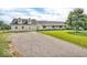 Inviting home with a charming porch, a side balcony, and a spacious gravel driveway at 10705 N State Road 267, Brownsburg, IN 46112