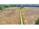 A view of the driveway to the property, divided by farmland and prairie at 10705 N State Road 267, Brownsburg, IN 46112