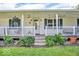 Inviting front porch with a well-manicured garden offering curb appeal and a warm welcome at 10705 N State Road 267, Brownsburg, IN 46112