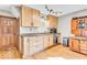 Well-lit kitchen featuring wood cabinets, stainless steel appliances, and hardwood flooring at 10705 N State Road 267, Brownsburg, IN 46112