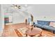 Bright living room featuring a blue sofa and hardwood floors at 10705 N State Road 267, Brownsburg, IN 46112