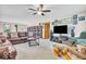 Comfortable living room with plush seating, a ceiling fan, and plenty of natural light at 10705 N State Road 267, Brownsburg, IN 46112