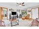 Comfortable living room with ample seating, a ceiling fan, and a view of the outdoors at 10705 N State Road 267, Brownsburg, IN 46112