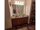 Bathroom featuring a double vanity with mirror and linen closet with wooden cabinets at 10775 Cyrus Dr, Indianapolis, IN 46231