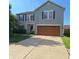 Charming two-story home featuring a two-car garage, tidy landscaping, and classic curb appeal at 10775 Cyrus Dr, Indianapolis, IN 46231