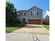 Charming two-story home featuring a two-car garage, tidy landscaping, and classic curb appeal at 10775 Cyrus Dr, Indianapolis, IN 46231
