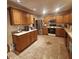 Kitchen featuring stainless steel appliances, wooden cabinets, and tile floors at 10775 Cyrus Dr, Indianapolis, IN 46231