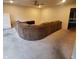 Spacious living room with a large sectional sofa and carpeted floors at 10775 Cyrus Dr, Indianapolis, IN 46231