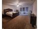 A comfortable main bedroom featuring natural light, ceiling fan and carpeted floors at 10775 Cyrus Dr, Indianapolis, IN 46231