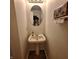 Cozy powder room with pedestal sink, decorative mirror, and stylish towel holder at 10775 Cyrus Dr, Indianapolis, IN 46231