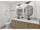 Well-lit bathroom boasting double sinks with modern fixtures, complementing the sleek design and ample counter space at 10778 Haverstick Rd, Carmel, IN 46033