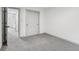 Bright bedroom featuring plush carpeting and a spacious closet with neutral paint, ready to be personalized at 10778 Haverstick Rd, Carmel, IN 46033