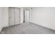 An inviting, empty bedroom with neutral colors, plush carpeting, and a spacious closet, ready to be personalized at 10778 Haverstick Rd, Carmel, IN 46033