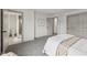 Spacious bedroom showcasing neutral paint, plush carpet, and an ensuite bathroom, perfect for relaxation at 10778 Haverstick Rd, Carmel, IN 46033