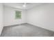 An inviting, empty bedroom with neutral colors and plush carpeting, bathed in natural light from a bright window at 10778 Haverstick Rd, Carmel, IN 46033