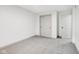 An inviting, empty bedroom with neutral colors, plush carpeting, and a spacious closet, ready to be personalized at 10778 Haverstick Rd, Carmel, IN 46033