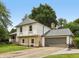 A charming two-story home featuring stone accents, neutral siding, and an attached two car garage at 10778 Haverstick Rd, Carmel, IN 46033