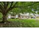 Charming two-story home with stone accents, a well-manicured lawn, and mature trees for shade at 10778 Haverstick Rd, Carmel, IN 46033