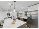 Bright kitchen featuring stainless steel appliances, a large island, and modern pendant lighting at 10778 Haverstick Rd, Carmel, IN 46033