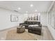 Cozy living room with a large sectional sofa, area rug, and window with natural light at 10778 Haverstick Rd, Carmel, IN 46033