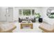 Inviting living room with neutral tones, stylish furniture, a large window, and a decorative coffee table at 10778 Haverstick Rd, Carmel, IN 46033