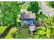 Charming blue home featuring a sunroom and large wooden deck, perfect for outdoor entertaining, nestled within a lush yard at 1099 Saratoga Cir, Carmel, IN 46280