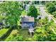 Charming blue home featuring a sunroom and large wooden deck, perfect for outdoor entertaining, nestled within a lush yard at 1099 Saratoga Cir, Carmel, IN 46280