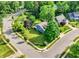 Beautifully landscaped property with a well-maintained lawn, mature trees, and charming blue house on a corner lot at 1099 Saratoga Cir, Carmel, IN 46280