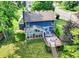 Charming blue home featuring a sunroom and large wooden deck, perfect for outdoor entertaining, nestled within a lush yard at 1099 Saratoga Cir, Carmel, IN 46280