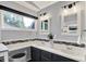 Bright bathroom featuring a double vanity, sleek fixtures, and a large window at 1099 Saratoga Cir, Carmel, IN 46280