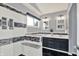 Modern bathroom featuring a walk-in shower, double vanity, and black tiled floors at 1099 Saratoga Cir, Carmel, IN 46280