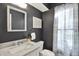 Modern bathroom with marble countertop vanity, updated fixtures, and a framed mirror at 1099 Saratoga Cir, Carmel, IN 46280