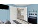 Charming bedroom with blue walls, a sleek TV, and easy access to other rooms in the house at 1099 Saratoga Cir, Carmel, IN 46280