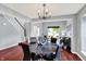 Elegant dining room features a modern chandelier and a view into the living room and staircase at 1099 Saratoga Cir, Carmel, IN 46280