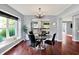 Bright dining room boasts a modern chandelier and sleek black dining chairs around a dark marble table at 1099 Saratoga Cir, Carmel, IN 46280