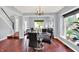 Elegant dining room features a modern chandelier and a view into the living room and staircase at 1099 Saratoga Cir, Carmel, IN 46280