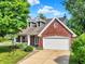 Charming brick house with a well-manicured front yard, showcasing curb appeal and welcoming charm at 1099 Saratoga Cir, Carmel, IN 46280