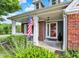 Inviting front entrance featuring a decorative door, flag, and a well-manicured landscape at 1099 Saratoga Cir, Carmel, IN 46280