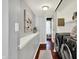 Hallway that leads to the laundry room, featuring modern black appliances and updated paint at 1099 Saratoga Cir, Carmel, IN 46280