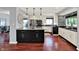 Open concept kitchen with dark island, granite countertops, and stainless steel appliances at 1099 Saratoga Cir, Carmel, IN 46280