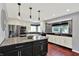 Modern kitchen with granite countertops, stainless steel appliances, and mosaic tile backsplash at 1099 Saratoga Cir, Carmel, IN 46280