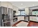 Updated kitchen features stainless steel appliances, white cabinetry, and ample counter space at 1099 Saratoga Cir, Carmel, IN 46280