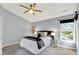 Bedroom with a ceiling fan, neutral paint, and a view of the yard at 1099 Saratoga Cir, Carmel, IN 46280