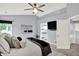 Spacious main bedroom with a ceiling fan, neutral paint, and a view into the bathroom at 1099 Saratoga Cir, Carmel, IN 46280