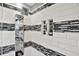 Bathroom walk-in shower featuring multiple shower heads and a tiled shelf at 1099 Saratoga Cir, Carmel, IN 46280