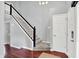 Foyer with a carpeted staircase featuring white risers and dark handrail at 1099 Saratoga Cir, Carmel, IN 46280