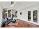 Inviting sunroom with wood floors, vaulted ceilings, skylight, and large windows overlooking the backyard at 1099 Saratoga Cir, Carmel, IN 46280