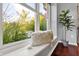 Cozy window seat with textured pillow, next to a potted plant and view of the outdoors at 1099 Saratoga Cir, Carmel, IN 46280