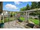 A backyard with a quaint wooden deck and frame leading to a well maintained and manicured lawn at 1106 Summer Way Ct, Shelbyville, IN 46176
