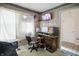 Small bedroom featuring a computer setup and a window covered with a white sheet at 1106 Summer Way Ct, Shelbyville, IN 46176